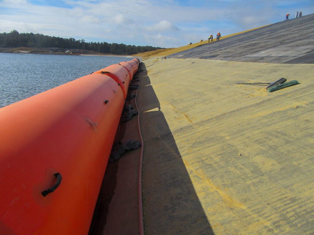 Hall Earth Moving required an inflatable aquatic safety barrier to protect men deploying and welding the liner against entry into the tailings water during construction.